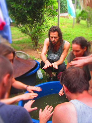 ayahuasca foundation course students pray over a plant remedy